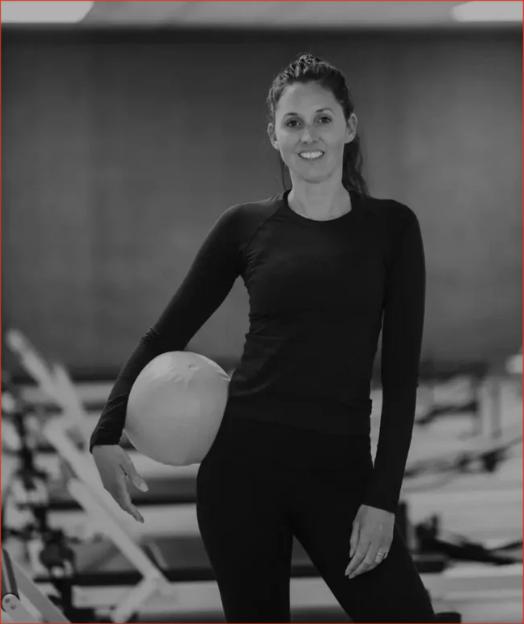 Pilates Reformer NZ owner holding medicine ball