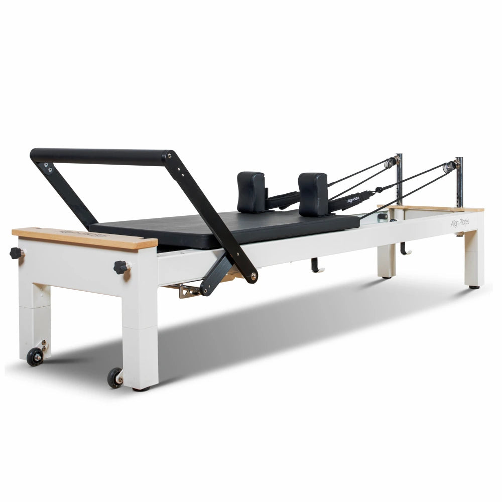 White Pilates reformer with wooden accents